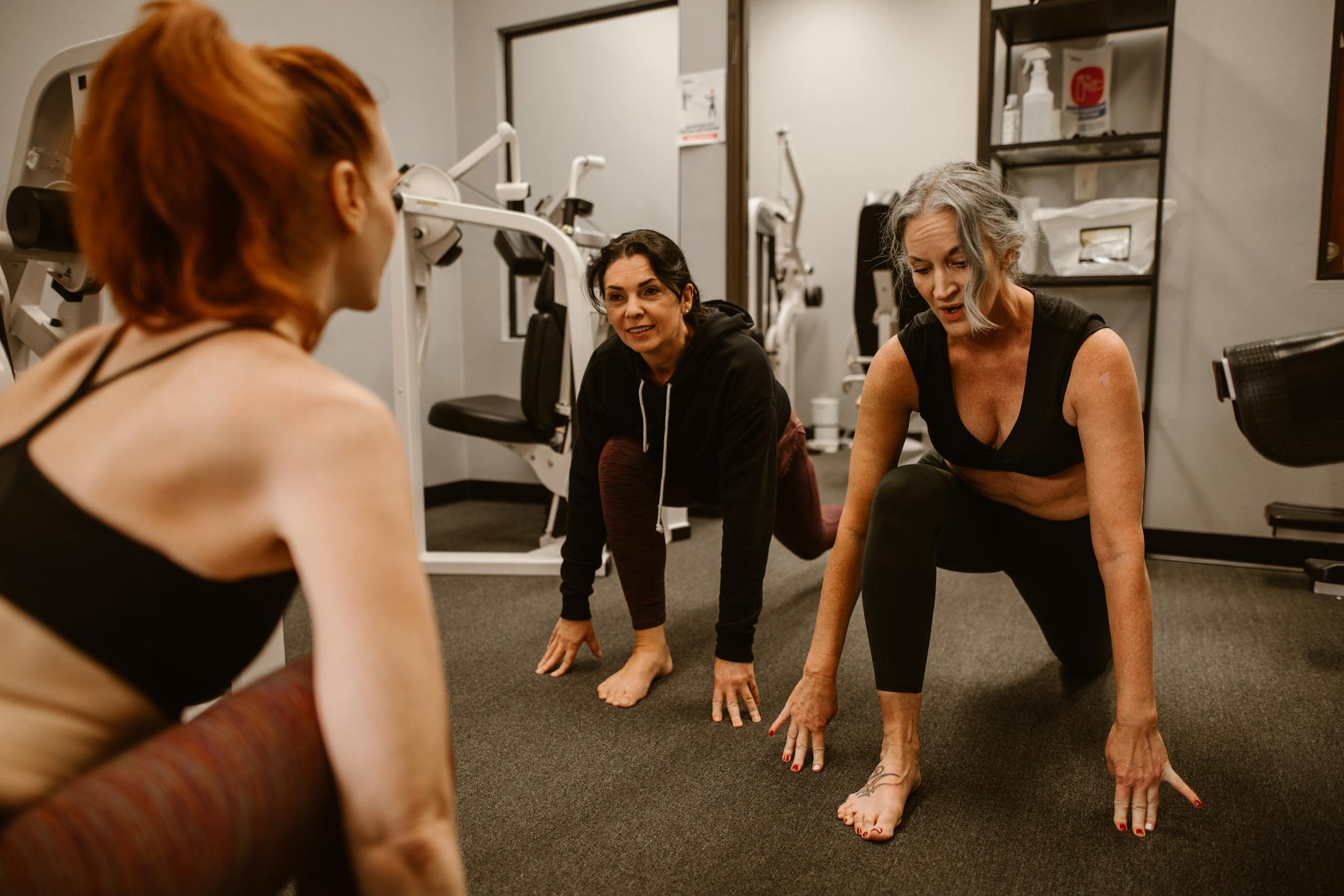 Women engaging in fitness exercises promoting wellness and a healthy lifestyle in the gym.